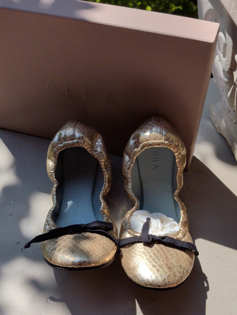 AERA Metallic Gold Ballet Flats with Black Bow